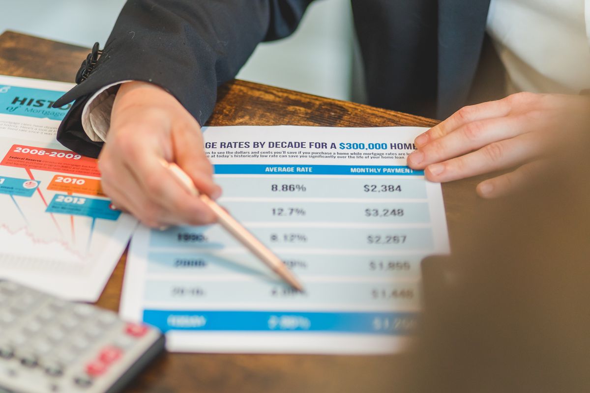 Reviewing mortgage numbers with a calculator to see how much house you can afford in Cary NC