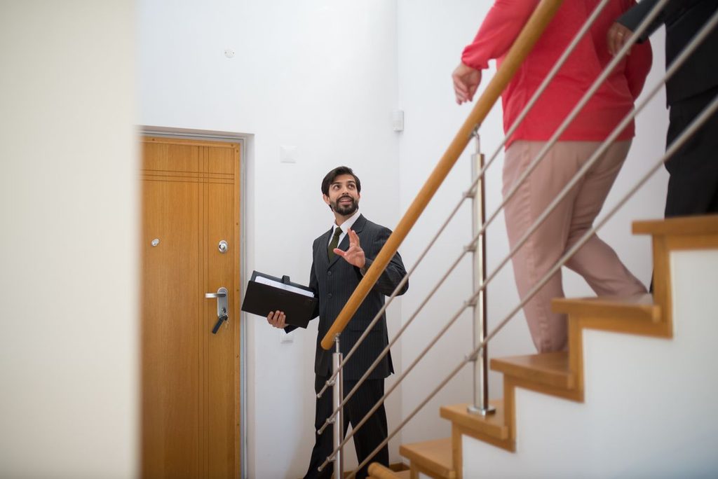 Cary housing market: real estate agent touring a home with prospective buyers