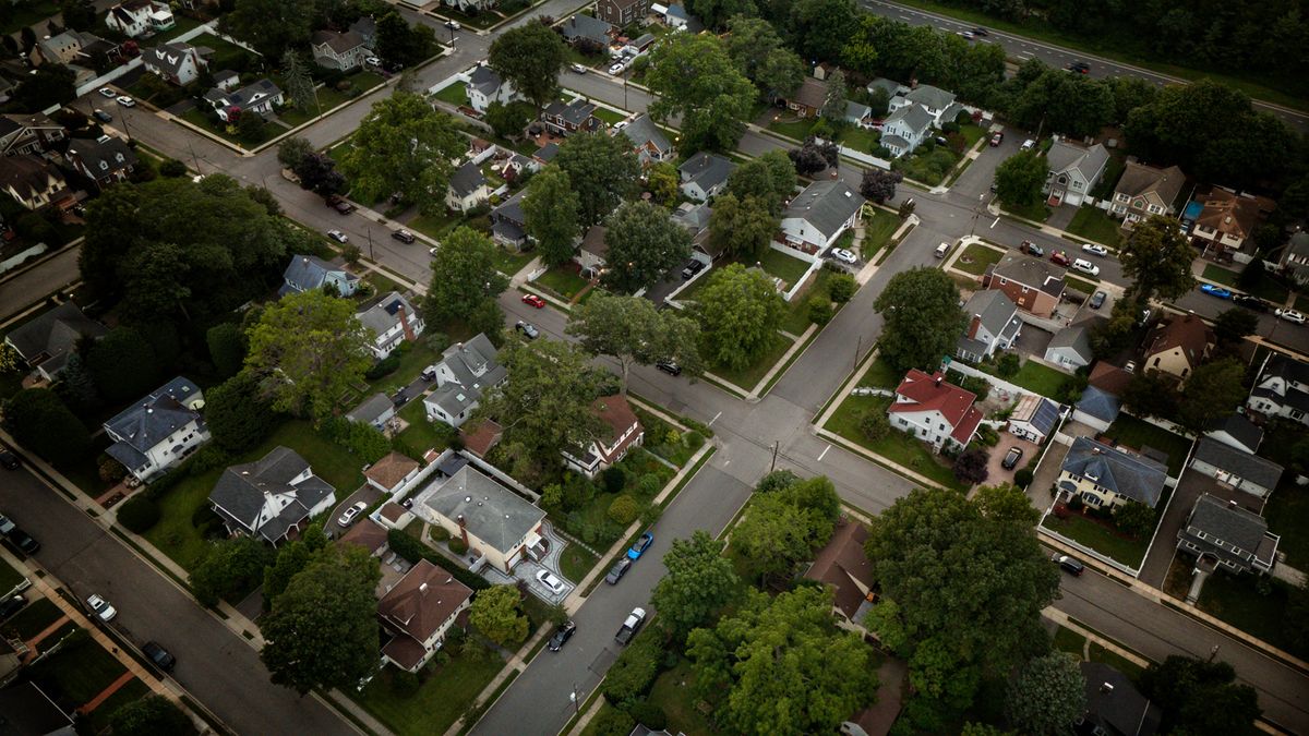 Aerial view of a tree-lined residential neighborhood, representing living in Cary NC