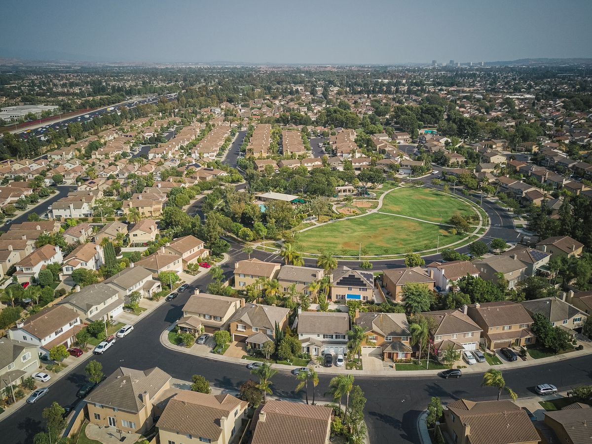 Aerial view of a suburban neighborhood and park, like many you will find when moving to Cary NC