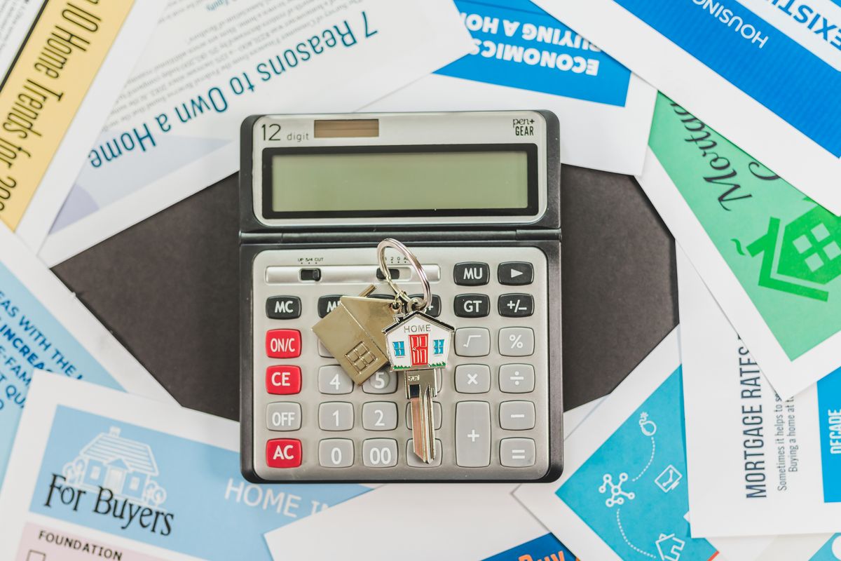 Calculator, keys and documents for budgeting with NC first-time homebuyer programs