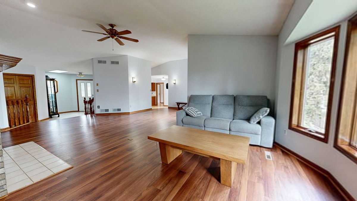 Bright staged living room with hardwood floors and neutral decor, an example of home staging tips Raleigh sellers use