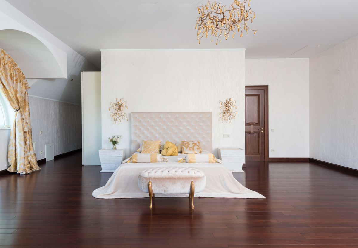 Light, neatly staged primary bedroom showing home staging tips for Raleigh area sellers
